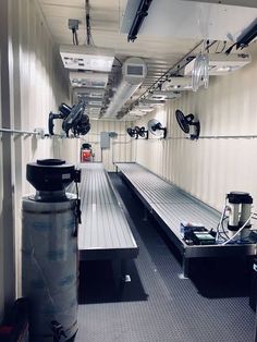 the inside of a storage room with benches and lights