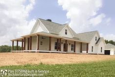 a large white house sitting on top of a lush green field