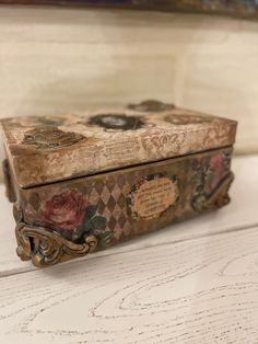 an old wooden box sitting on top of a white table