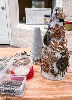 a wooden table topped with lots of different types of jewelry on it's sides