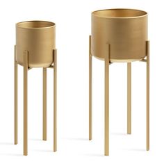 two gold planters sitting next to each other