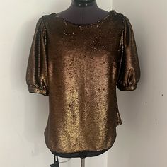 Bronze/Gold Sequin Top With Black Background And Puff Sleeves. Nwt. Some Missing Sequins, But It’s Hard To Tell. Bust Is Around 18.5” Flat, Length Is Around 25”. Puff Sleeve Padded Blouse For Evening, Fall Evening Top With Puff Sleeves, Evening Puff Sleeve Tops For Fall, Glamorous Short Sleeve Blouse For Fall, Puff Sleeve Padded Blouse For Party, Glamorous Padded Blouse For Evening, Glamorous Puff Sleeve Tops For Evening, Glamorous Padded Blouse Tops For Fall, Glamorous Padded Blouse For Fall