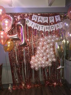 balloons and streamers decorate the backdrop for a birthday party