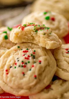 cookies with sprinkles stacked on top of each other in a red bowl