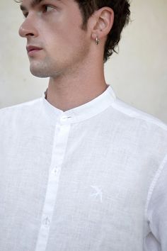 Perfect linen shirt with decorative embroidery "Swallow" could be a formal outfit and also free style. The shirt suit for men who appreciates sophistication and minimalism.  Stand-up collar Length: 70 cm Straight cut, oversized Dropped shoulder seam Long sleeve with cuff, small embroidery ""Swallow"" in white color on the left side Buttons made from seashells  Made of 100% natural linen, Oeko-Tex certified, free of harmful chemicals. It keeps the temperature of the body + -4 degrees, these cloth Classic Summer Shirt With Stand Collar, Formal White Linen Shirt, White Linen Formal Shirt, Elegant White Linen Shirt, Linen White Shirt, Men Linen Shirt, Office Shirt, White Shirt Men, The Office Shirts