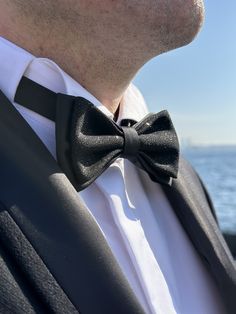 ✨ Elevate your style with our handmade black satin bow tie, exuding a boutique look. This eye-catching design features two layers of glittered satin, perfect for making a statement on your most special occasions. Whether you're a groom, attending a gala, or enjoying a costume party, this bow tie adds a touch of classic elegance with a hint of sparkle. It's a versatile choice that pairs well with any color suit or tuxedo.  Usage Area Suggestions 🎩 Wedding Elegance: Add a touch of glamour to your Fitted Bow Tie For Groom, Bow Tie For Men, Black Bow Tie, Costume Parties, Tie For Men, Mens Bow Ties, Satin Bow, Awards Ceremony, Black Bow