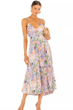 Florals for spring is a no-brainer, and this gorgeous midi from ASTR the Label is our top pick. "The pretty pleated skirt, pastel hues, and floral print make this the perfect choice for every spring wedding on your calendar," says Brides shopping editor, Chloe Caldwell. "I also adore the cut-outs and feminine tie-closure in the back for an unexpected detail." Beach Wedding Guest Dresses, Spring Wedding Guest Dresses, Wedding Guest Outfit Inspiration, Garden Formal, Beach Formal, Formal Wedding Attire, Beach Wedding Guest, Spring Wedding Guest Dress, Beach Wedding Guest Dress