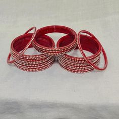 Bangles Name - Penali sheikh   Color - red   Size - 2.2/2.4/2.6/2.8   Weight - 60 grams   Piece - 12   Stone Color- WHITE  100% Glass Bangles & Handmade Product. You can wear it while going to a wedding by matching it with your clothes. You can also gift it to someone. You can also wear it in an engagement. It looks very beautiful in your hands. about shipping  Ships within 1 to 3 business days after payment is received  We ship orders every day except Sundays and holidays  When your order is sh Red Round Bangle For Party, 12 Stones, Glass Bangles, Bangles For Women, Handmade Bangles, Bangles Style, Air Mail, Red Color, Stone Color