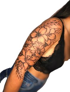 a woman's arm with flowers on it and a black lace around the arm