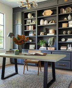 an office with built in bookshelves and shelves