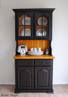 a black china cabinet with two glass doors