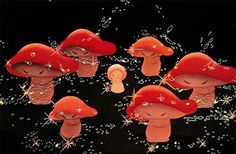 four little red mushrooms with sparklers in their hands and one is holding a candle