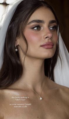 a woman wearing a wedding veil and earrings with the words, this bridal makeup is perfect for every bride