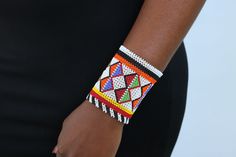 African beaded bracelets, Maasai Cuff Bracelets, Maasai Wrist bracelets, Beaded bangles, Beaded Cuff bracelets, Christmas gift, Moms gift The bracelet is made by the Maasai women in Kenya.  It is beautiful and can compliment any outfit. Available in medium and large size Medium size: fits a standard wrist size of 7.5 inches Large Size: fits a wrist size of 8.5 inches Shipping fee is for the first item only. Other items ship for FREE! Shipping via DHL Express that takes 3-5 days to be delivered. To view more items from our shop, kindly click here: nkoroicrafts.etsy.com Thank you for visiting! White Beaded Bangle Bracelets For Festive Occasions, Maasai Jewelry, African Beaded Bracelets, Bracelets Christmas, Beaded Bangles, Bracelets Beaded, Diy Friendship Bracelets Patterns, Beaded Cuff Bracelet, Bead Loom Bracelets