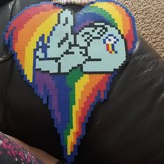 the back of a black leather couch covered in pixel art