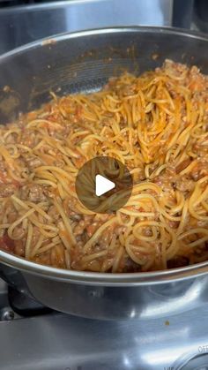 spaghetti being cooked in a pan on the stove