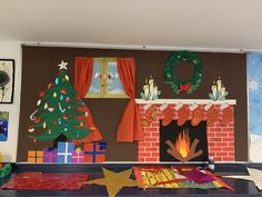 a fireplace decorated for christmas with decorations on the mantle