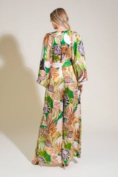 A printed woven jumpsuit featuring V neckline, kimono sleeve, front pleats, wide leg, split back and button zipper closure Details: Self : 97% Polyester 3% Spandex Size & Fit - Model is 5`8" And Wearing Size Small- Measurements Taken From Size Small- Approx. Length: 58" Multicolor Tropical Print V-neck Jumpsuits And Rompers, Chic Long Sleeve Jumpsuits And Rompers For Vacation, Chic Long Sleeve Jumpsuits For Vacation, Long Sleeve Printed Jumpsuits For Beach, Long Sleeve Printed Jumpsuits And Rompers For Beach, Long Sleeve Printed Jumpsuits For The Beach, Chic Green Long Sleeve Jumpsuits And Rompers, Printed Green Jumpsuits And Rompers For Vacation, Green Printed Jumpsuits And Rompers For Vacation