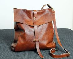 Minimalist convertible bag, Leather brown shoulder bag, Very large backpack bag and crossbody, Oversized backpack, Leather Caryall Bag Dimension details: Max width at the top: 14,5 inch Height: 15,5 inch Width at the base: 14,5 inch Depth: 5,5 inch Short strap:18 inch Long strap:60 inch A great everyday bag with a minimalist look it can be worn as a bag, backpack or crossbody. - Brown color - Made of thick yet soft cattle leather. - Inside cotton lining - Top closure magnet for security Add this Large Capacity Everyday Tote Saddle Bag, Everyday Large Capacity Tote Saddle Bag, Everyday Large Capacity Saddle Tote Bag, Brown Crossbody Duffle Bag For Daily Use, Brown Shoulder Duffle Bag For Everyday Use, Brown Large Capacity Crossbody Duffle Bag, Brown Duffle Bag With Adjustable Strap And Backpack Shape, Brown Backpack Duffle Bag For Daily Use, Brown Backpack Duffle Bag For Everyday Use