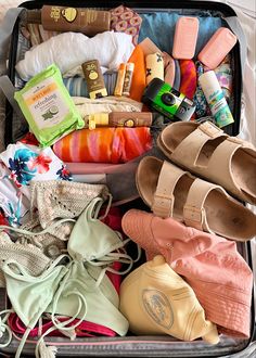 an open suitcase filled with shoes and other items