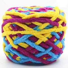 a ball of multicolored yarn on a white surface