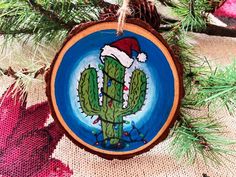 a christmas ornament with a cactus painted on it