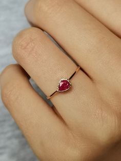 Natural Ruby Ring handcrafted in 14k gold, tear drop ring, 14k gold ring. This is a beautiful ruby ring with tiny heart cut out in the back - 100% handcrafted which can become a wonderful treasure to cherish for years to come. Ruby is July birthstone. CENTRAL STONE: * natural, Earth mined gemstone- ruby * teardrop placed horizontally APPROXIMATE MEASUREMENTS OF THE RING: *band: approximately 1 mm *material: 14k gold (yellow/rose/white) *size- please pick from the drop down menu. If you need othe Rose Gold Ruby Ring For Promise, Fine Jewelry Ruby Ring As Gift, Engraved Ruby Ring For Gift, Rose Gold Ruby Ring With Bezel Setting For Gift, Rose Gold Ruby Ring With Bezel Setting As Gift, 14k Gold Ruby Ring Gift, Yellow Gold Ruby Diamond Ring Gift, Dainty Ruby Ring For Formal Occasions, Rose Gold Ruby Jewelry For Promise