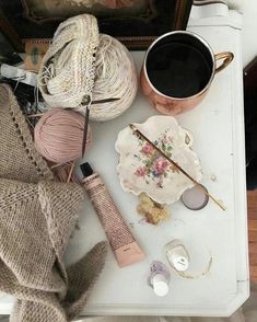 a table topped with yarn and other items