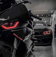 two motorcycles parked next to each other in a garage