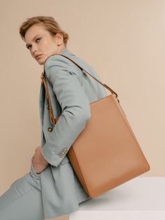 The Allured Medium Tote bag is a medium-sized version of our beloved Allured Tote Bag. The rectangular silhouette sits perfectly on the shoulder, offering a wide leather strap adjustable with the belt loop detail. Lined with smooth leather, the bag fits 11" laptop, making it the perfect everyday tote. - Full-grain togo calfskin leather imported from Italy - Matching color smooth calfskin leather interior - Removable and adjustable shoulder strap - Product Care - Width: 10” - Height: 12.5" - Dept Medium Tote Bag, Airpods Pro Case, Lightweight Bag, Work Tote, Everyday Tote, Medium Tote, How To Make Shorts, Day Bag, Work Bag