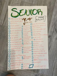 someone is holding up a paper with the word senior year written on it