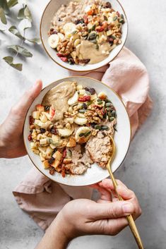 two bowls filled with food on top of a table