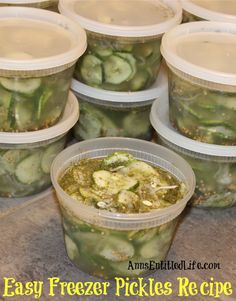 several plastic containers filled with pickles sitting on top of a counter next to each other