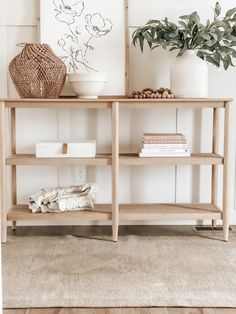 a wooden shelf with books and plants on it