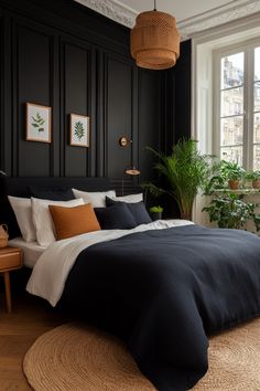 a bedroom with black walls and white bedding