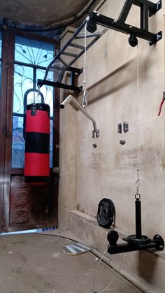 a red and black fire extinguisher hanging from the ceiling