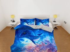 a bed with two dolphins on it in a room next to a night sky and stars