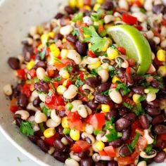 a white bowl filled with black beans, corn and cilantro garnish