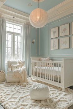 a baby's room with blue walls and white furniture