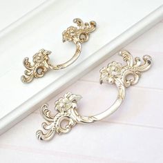 two silver handles on the side of a white door