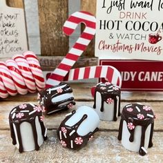 chocolate candies and candy canes sitting on a table