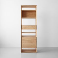 an empty wooden book shelf against a white wall with no one in the room or furniture