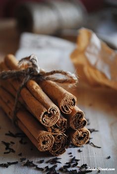 cinnamon sticks tied with twine on top of a table