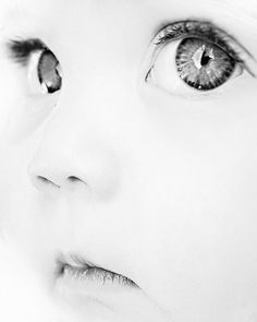 a close up of a child's face with blue eyes