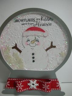 snowflakes are kisses from heaven on the front of a christmas ornament