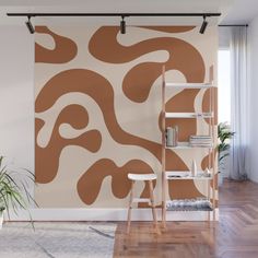 a living room with a large wall mural in the shape of an abstract design on it