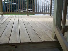 a wooden deck with metal railings in the background