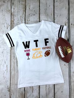 WTF Wine Turkey Football - Women's Football V-Neck Fine Jersey Tee Perfect Family Holiday Gathering Shirt! BRAND & MATERIAL: LAT Women's Football V-Neck Fine Jersey Tee - 4.5 oz., 60/40 combed ringspun cotton/polyester, 30 singles - Black/White and White/Black are 100% combed ringspun cotton - Two contrast stripes on sleeves - Front yoke - Topstitch mitered v-neck collar - EasyTear™ label Discount available on bulk orders! Any questions, please message us before placing your order and we wou V-neck Letter Print T-shirt For Fall, Game Day V-neck Top With Letter Print, V-neck Game Day Top With Letter Print, V-neck Tops With Letter Print For Game Day, V-neck Letter Print Tops For Game Day, Fall V-neck T-shirt With Letter Print, Fall Letter Print V-neck T-shirt, Fall V-neck Graphic Tee T-shirt, Funny Football Shirts