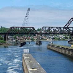 a large bridge over a river next to a small town