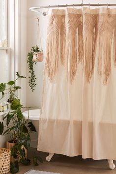 a shower curtain with tassels hanging from it's side in a bathroom